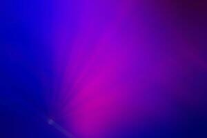 Blurred pink rays from the stage light on a purple background. Purple pink gradient. photo