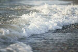 White foam from the sea wave close up. photo