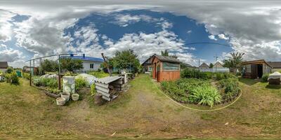 360 hdri panorama view in garden with flower bed yard near wooden eco house in village in equirectangular spherical projection. for VR AR content photo