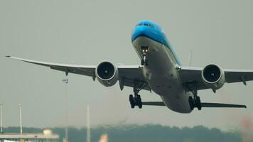 AMSTERDAM, THE NETHERLANDS JULY 27, 2017 - Passenger jet of KLM Airlines taking off at Schiphol Airport, Amsterdam. Landing gear closing, climb. Tourism and travel concept video