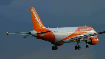 AMSTERDAM, THE NETHERLANDS JULY 25, 2017 - EasyJet Airbus 319 G EZFE approaching before landing at runway 06 Kaagbaan at sunrise, slow motion. Shiphol Airport, Amsterdam, Holland video