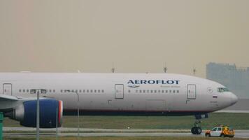 MOSCOW, RUSSIAN FEDERATION JULY 28, 2021 - Boeing 777 of Aeroflot on the runway at Sheremetyevo Airport. Airplane taxiing, side view. Tourism and travel concept video