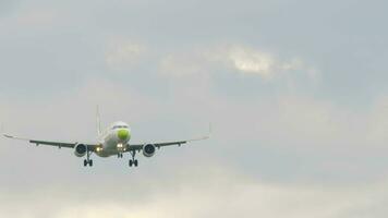 Front view of an airliner descending for landing. Footage of a commercial aircraft flying. Tourism and travel concept video