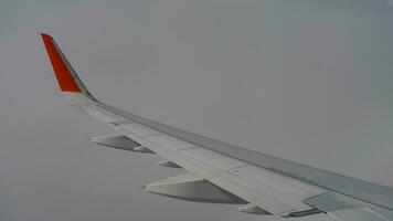 Wing of airplane on sky and cloud on moving, view from airplane cabine video