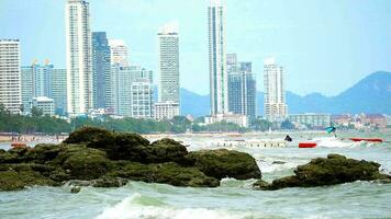 Tourists come to relax and swim in the sea in summer and sea waves and strong winds hit the rocks video