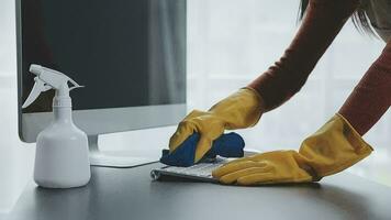 Cleaning company employee wipes dust from table in office video