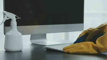 Cleaning company employee wipes dust from table in office video