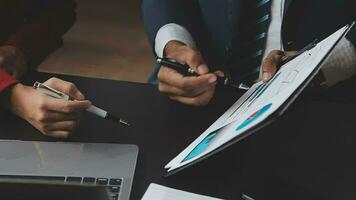 Financial Business team present. Business man hands hold documents with financial statistic stock photo, discussion, and analysis report data the charts and graphs. Finance Financial concept video
