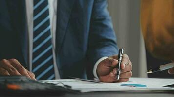 Financial Business team present. Business man hands hold documents with financial statistic stock photo, discussion, and analysis report data the charts and graphs. Finance Financial concept video