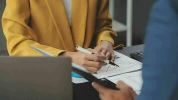 Financial Business team present. Business man hands hold documents with financial statistic stock photo, discussion, and analysis report data the charts and graphs. Finance Financial concept video