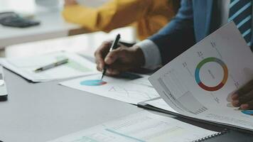 Financial Business team present. Business man hands hold documents with financial statistic stock photo, discussion, and analysis report data the charts and graphs. Finance Financial concept video