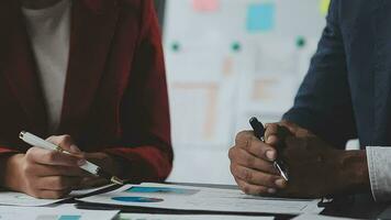 Financial Business team present. Business man hands hold documents with financial statistic stock photo, discussion, and analysis report data the charts and graphs. Finance Financial concept video