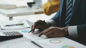 Financial Business team present. Business man hands hold documents with financial statistic stock photo, discussion, and analysis report data the charts and graphs. Finance Financial concept video