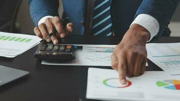 Financial Business team present. Business man hands hold documents with financial statistic stock photo, discussion, and analysis report data the charts and graphs. Finance Financial concept video