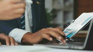 Financial Business team present. Business man hands hold documents with financial statistic stock photo, discussion, and analysis report data the charts and graphs. Finance Financial concept video