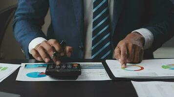 Financial Business team present. Business man hands hold documents with financial statistic stock photo, discussion, and analysis report data the charts and graphs. Finance Financial concept video