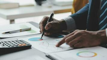 Financial Business team present. Business man hands hold documents with financial statistic stock photo, discussion, and analysis report data the charts and graphs. Finance Financial concept video
