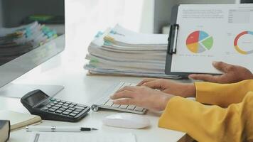 Financial Business team present. Business man hands hold documents with financial statistic stock photo, discussion, and analysis report data the charts and graphs. Finance Financial concept video