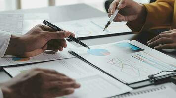 Financial Business team present. Business man hands hold documents with financial statistic stock photo, discussion, and analysis report data the charts and graphs. Finance Financial concept video