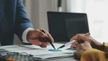 Financial Business team present. Business man hands hold documents with financial statistic stock photo, discussion, and analysis report data the charts and graphs. Finance Financial concept video
