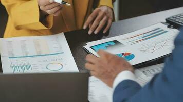 Financial Business team present. Business man hands hold documents with financial statistic stock photo, discussion, and analysis report data the charts and graphs. Finance Financial concept video