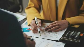 Financial Business team present. Business man hands hold documents with financial statistic stock photo, discussion, and analysis report data the charts and graphs. Finance Financial concept video
