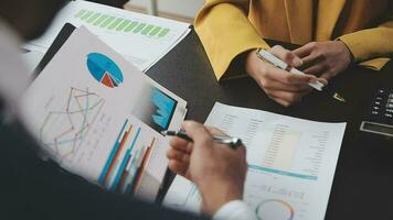 Financial Business team present. Business man hands hold documents with financial statistic stock photo, discussion, and analysis report data the charts and graphs. Finance Financial concept video