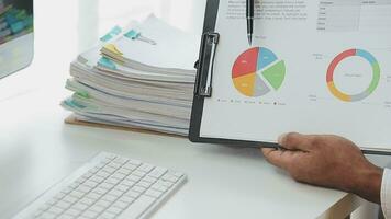 Financial Business team present. Business man hands hold documents with financial statistic stock photo, discussion, and analysis report data the charts and graphs. Finance Financial concept video