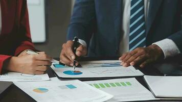 Financial Business team present. Business man hands hold documents with financial statistic stock photo, discussion, and analysis report data the charts and graphs. Finance Financial concept video
