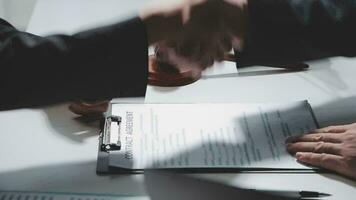 Businessman shaking hands to seal a deal with his partner lawyers or attorneys discussing a contract agreement video