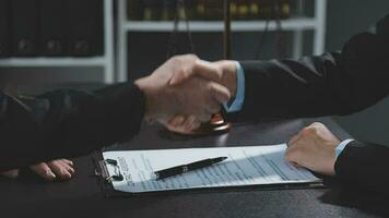 Businessman shaking hands to seal a deal with his partner lawyers or attorneys discussing a contract agreement video