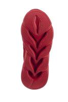 Red rubber corrugated sole from sports shoes. photo