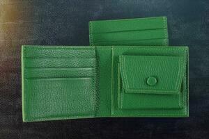 Leather products. Wallet business card holder made of green leather on a black background. photo