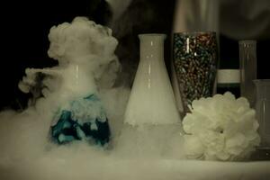 In a chemical laboratory, flasks filled with solutions in smoke. photo