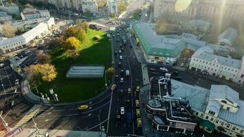 An aerial view of a small traffic roundabout in the middle of sunny urbanscape video