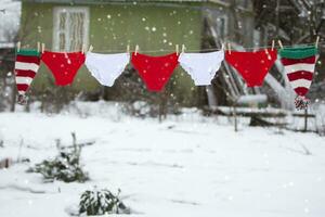 Red and white shorts are hung in the form of a Christmas garland. photo