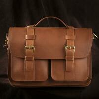 Brown leather briefcase bag on a dark background. photo