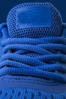 Vertical fragment of blue sneaker close up photo