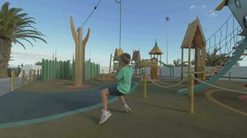 Boy having fun on large playground video