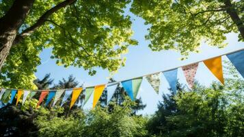 Colorful bunting at the party with trees behind it photo