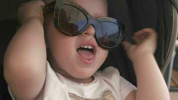 Lovely baby girl in mums sunglasses video