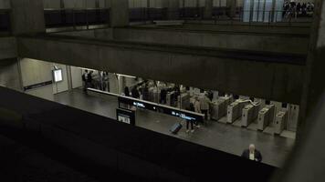 A top view of people walking through automatic turnstiles video
