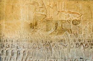 Carved Stone Wall of Khmer King Parade Story Bas Relief of Angkor Wat at Siem Reap Province of Cambodia photo