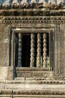 Carved Stone Wall and Window of Angkor Wat at Siem Reap Province of Cambodia photo