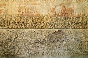 Carved Stone Wall of Hell Mythology Story Bas Relief of Angkor Wat at Siem Reap Province of Cambodia photo