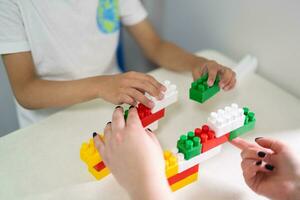 a small child plays with a constructor while building photo