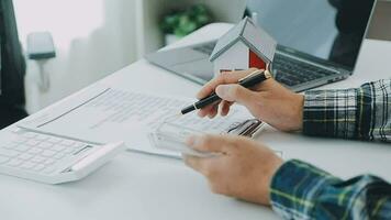 Real estate broker agent presenting and consult to customer to decision making sign insurance form agreement, buy and sell home model, concerning mortgage loan offer for and house insurance video