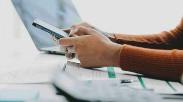 Asian Businesswoman Using laptop computer and working at office with calculator document on desk, doing planning analyzing the financial report, business plan investment, finance analysis concept. video