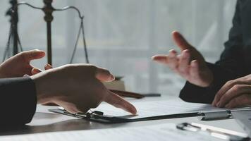 Businessman shaking hands to seal a deal with his partner lawyers or attorneys discussing a contract agreement video