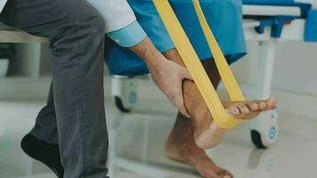 A physiotherapist doing treatment with patient in bright office video